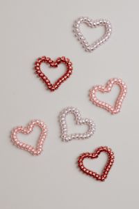 Kaboompics - Colorful Beaded Heart Shapes Scattered on a Pale Background, Valentine Flat Lay