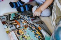 Kaboompics - Child reading a comic story