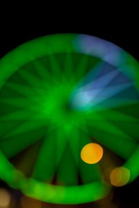 Kaboompics - Green Ferris Wheel Close-Up with a Blue-White Light Streak