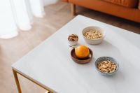 Kaboompics - Bright Living Room Snack Table with Cashews, Walnuts and Passion Fruit