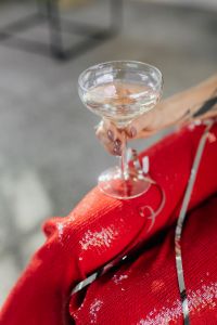 Kaboompics - Champagne Glass, Gold Bracelet and Red Party Outfit Detail