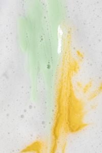 Kaboompics - Green and Yellow Skincare Cream Swatches in White Bubbly Foam, Colorful Macro