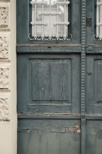 Kaboompics - Peeling Paint on Old Teal Wooden Door with Iron Window Bars, Italy