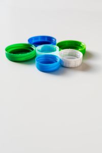 Kaboompics - Colorful Bottle Caps Clustered with White Copy Space