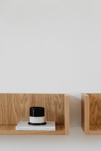 Kaboompics - Black Candle on Marble Plinth in Wooden Wall Shelf Nook