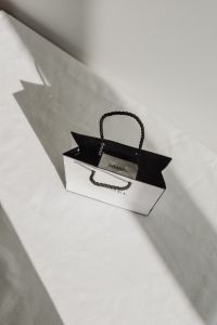 Kaboompics - Chanel Shopping Bag on White Fabric with Sunlight and Shadows