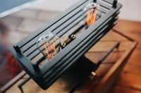 Kaboompics - Close-Up of a Black Linear Lamp with Exposed Edison Bulbs on a Wooden Table