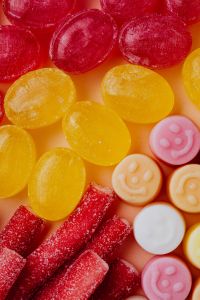 Kaboompics - Red and Yellow Jelly Candies with Pink Smiley Sweets, Colorful Macro