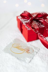 Kaboompics - Red Christmas Present and Gold Thank You Note with Winter Bokeh Lights