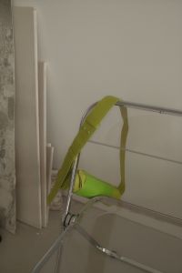 Kaboompics - Neon Green Bag Partly Hidden Behind Transparent Chair in Minimalist Interior