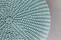 Kaboompics - Close-Up of Blue Knitted Pouf Ottoman with Spiral Center and Chunky Woven Texture