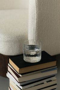 Kaboompics - Cozy Interior Still Life with Glass of Water on Stack of Books