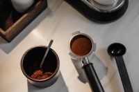 Kaboompics - Top View of Ground Coffee in Portafilter and Black Tamper