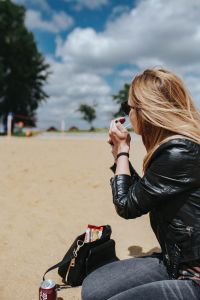 Kaboompics - Young woman smoking on the beach