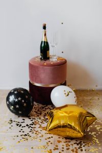 Kaboompics - New Year's Eve Party Setup With Champagne And Balloons On Confetti Floor