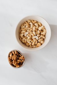 Kaboompics - Minimal Cashews and Walnuts on White Marble for Healthy Eating Campaigns