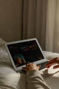 Kaboompics - Female Hands Using Laptop on Bed With Photo Gallery