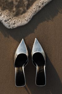 Kaboompics - Pair of Silver Heels on Wet Sand beneath the Foamy Shoreline