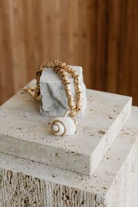 Kaboompics - Gold Necklace and Earrings on Stone Blocks