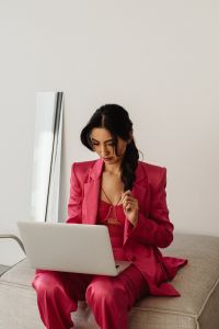 Kaboompics - Woman in Pink Suit Holding Laptop with Copy Space