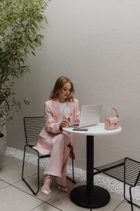 Kaboompics - Woman Working on a Laptop with a Pink Handbag