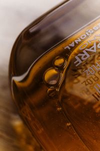 Kaboompics - Amber Cosmetic Bottle with Bubbles