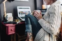 Kaboompics - Woman drinking hot tea in her home office