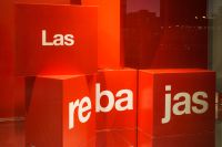Kaboompics - Red Las Rebajas Sale Display with Stacked Cubes and Copy Space