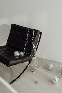 Kaboompics - Black Lounge Chair, Disco Balls and Long Metallic Streamers on White Floor