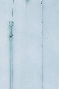 Kaboompics - Pale Blue Wall with a Vertical Metal Pipe