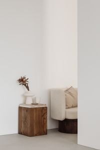 Kaboompics - Minimalist Interior with Walnut Pedestal, Upholstered Armchair and Tall Wall Copy Space