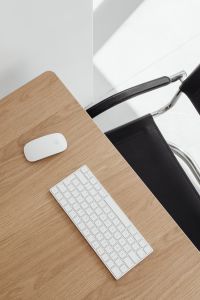 Kaboompics - Modern Oak Desk with White Keyboard and Chrome Office Chair