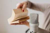 Kaboompics - Woman Turning Book Pages beside Microphone for Page-Turning ASMR Audio
