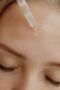 Kaboompics - Facial Serum Dropper Above Closed Eyes in a Skincare Macro