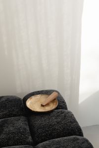 Kaboompics - Palo Santo in a Mother-of-Pearl Bowl on a Black Textured Ottoman