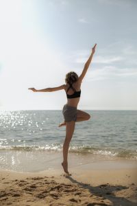 Kaboompics - Woman Practicing Yoga Tree Pose by the Sea