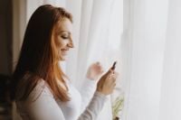 Kaboompics - Beautiful young woman using smartphone