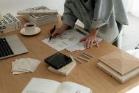 Kaboompics - Interior Designer Working with Sketches, Laptop and Surface Samples
