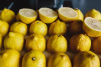 Kaboompics - Low-Angle Close-Up of Whole Lemons and Halved Citrus, Natural Food Still Life with Shallow Depth of Field