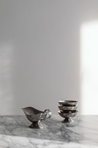 Kaboompics - Two Chrome Metal Vessels on Arabescato Marble