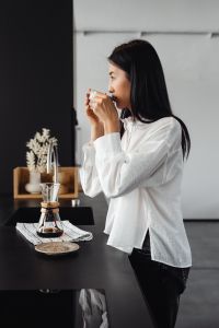 Kaboompics - Woman Drinking Coffee in a Minimal Kitchen