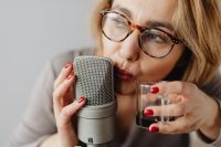 Kaboompics - Woman Drinking from a Wine Glass beside a Studio Microphone, ASMR Lifestyle