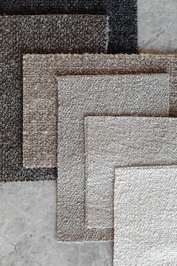 Kaboompics - Layered Neutral Bouclé Upholstery Fabric Swatches
