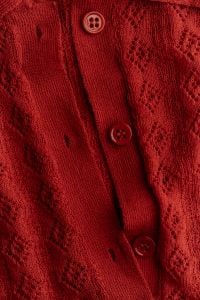 Kaboompics - Red Knitted Garment With Buttons and Textured Pattern