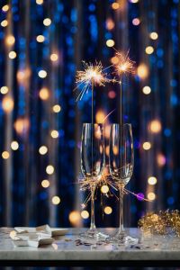 Kaboompics - Two Sparkling Champagne Flutes with Golden Lights for New Year's Eve