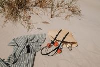 Kaboompics - Beach Setup with Striped Towel, Straw Bag and Peaches