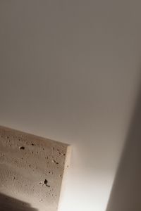 Kaboompics - Beige Wall with Porous Stone Slab and Hard Light