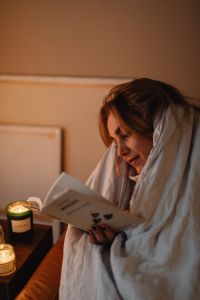 Kaboompics - Cocooning at Home with a Book and Lit Candle