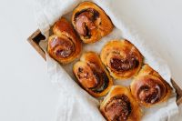 Kaboompics - Overhead Tray of Homemade Cinnamon Rolls on White Linen for Bakery Menus