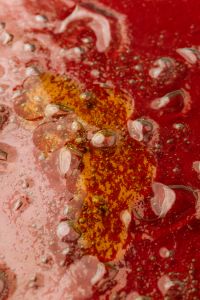Kaboompics - Red Pink Skincare Liquid with Gold Shimmer